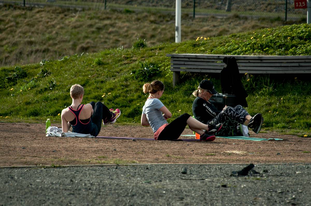 Person performing a lunge on a forest trail demonstrating outdoor fitness routines effectiveness